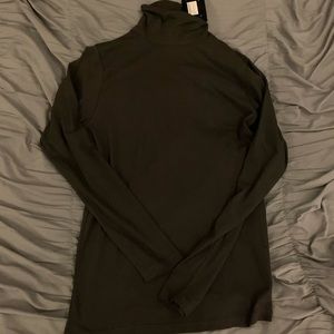 Muscle fit long sleeved roll neck in black